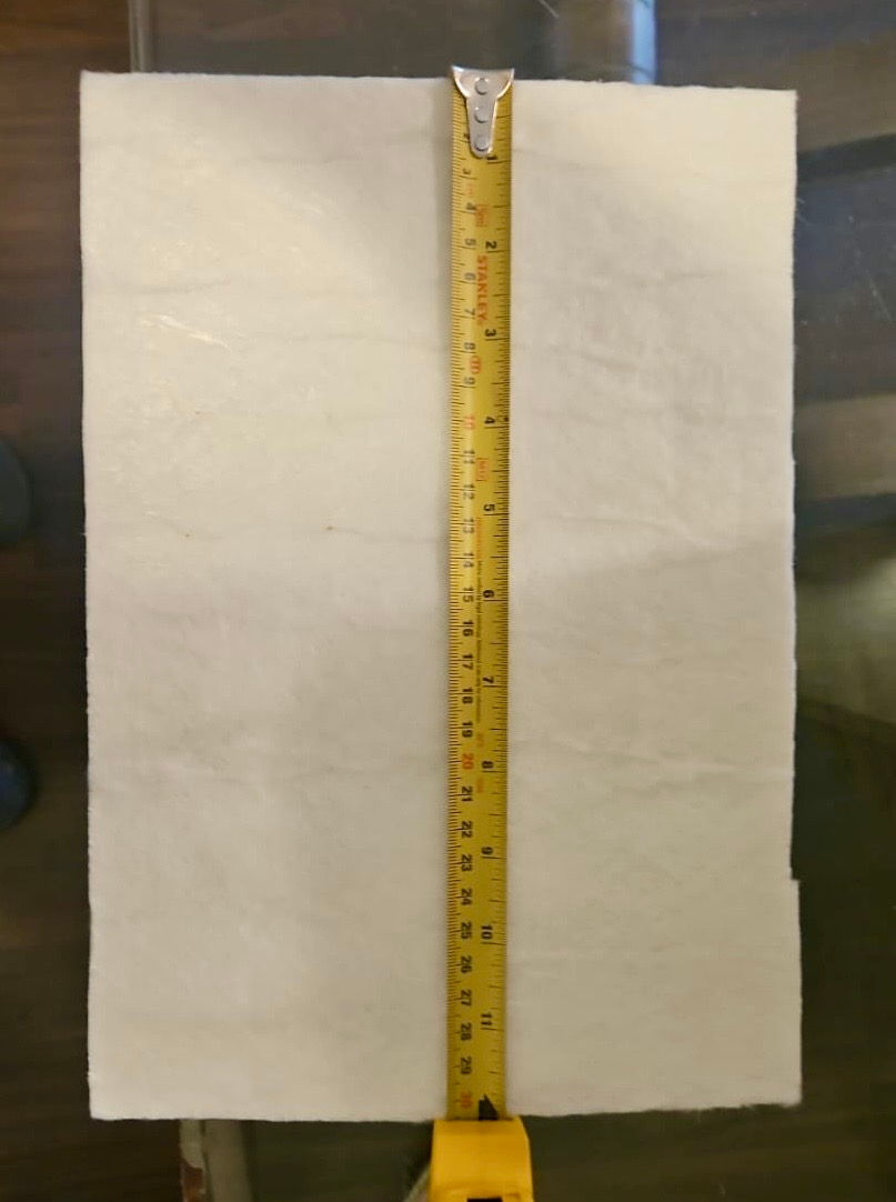 Close-up of aerogel thermal pad protecting an electric vehicle battery pack from heat damage.