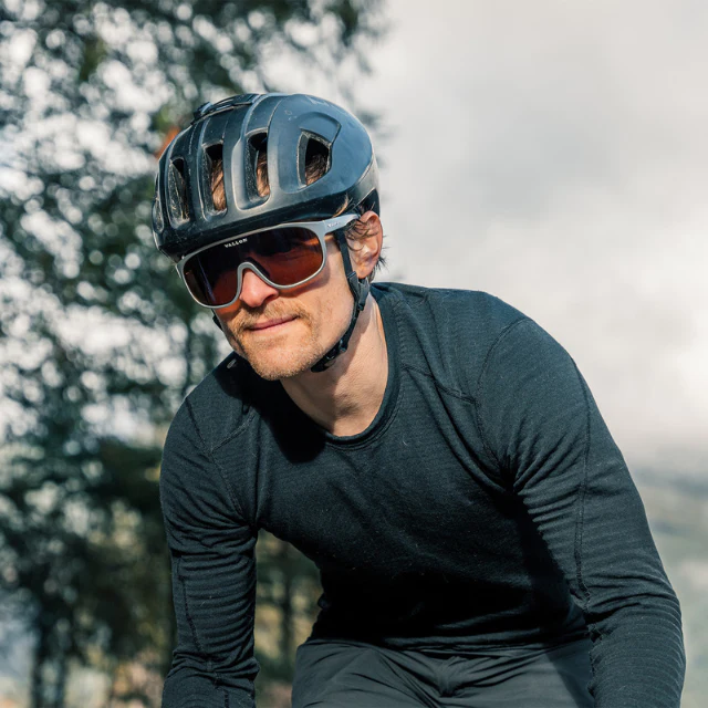 A close-up of a gravel cyclist wearing the Vallon Watchtowers sunglasses