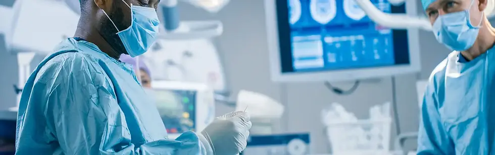 Two surgeons in a white coats and face masks operating a patient