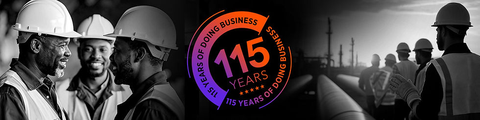 Workers in helmets converse at an industrial site. A colorful logo celebrates "115 years of doing business." Mood is collaborative.