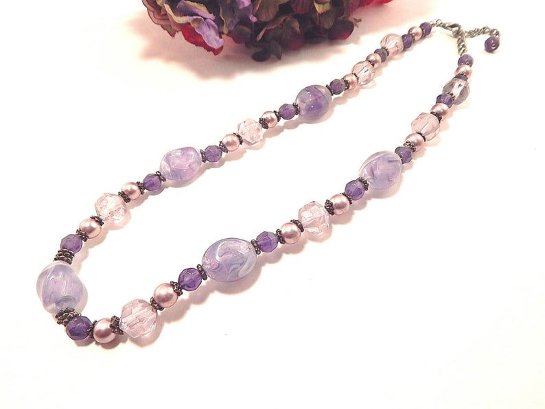 Thumbnail: faceted lavender and purple beads Pink/mauve faux pearl beads Silver metal findings, spacer beads, chain, and lobster claw