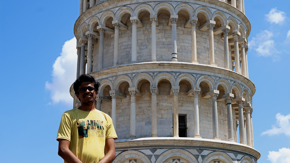 A boy in front of the Leaning tower of Pisa