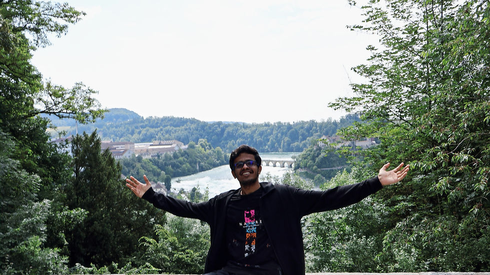 A boy posing against the Rhine falls