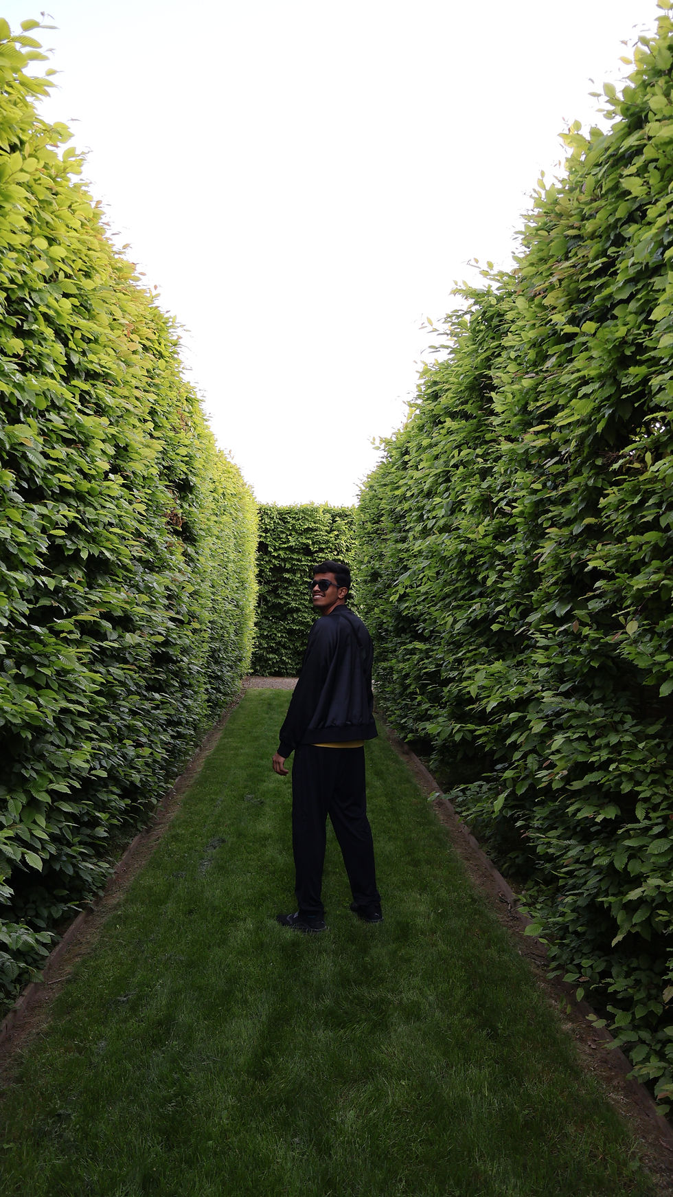 A cool boy posing against his back in the Herrenhäuser Gärten