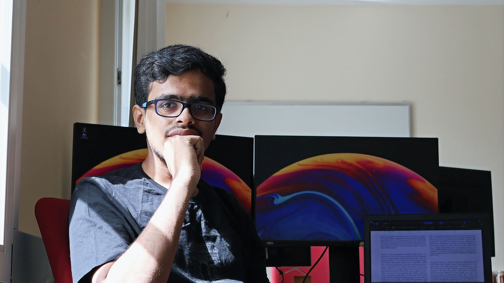 A beautiful boy posing against computers in his office