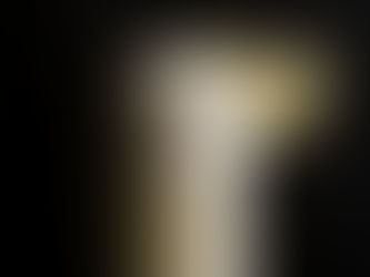 Creamy drink topped with foam in a glass, garnished with a lemon slice, set against a dark background. Cozy and refreshing mood.