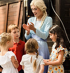 The Snow Queen clapping with children