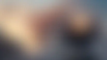 A cargo ship is standing, and two trucks are running at the port 