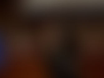 a woman smiling and holding a microphone presenting to a crowd of people