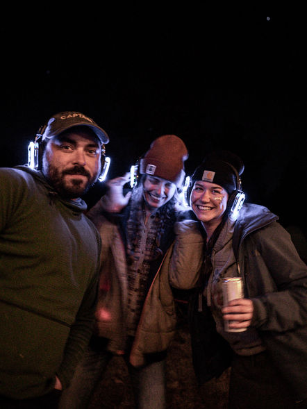 Joyful attendees immersed in the Camp Disco experience, a unique camping silent disco event at Twin Lakes campground by Silence at the Disco