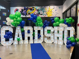 White and blue themed Corporate event company balloon arch with light up marquee letters