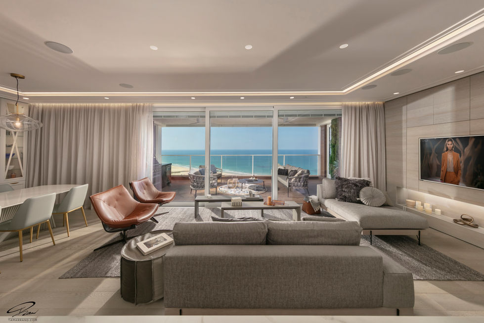 Luxurious living room with ocean view and modern furniture.