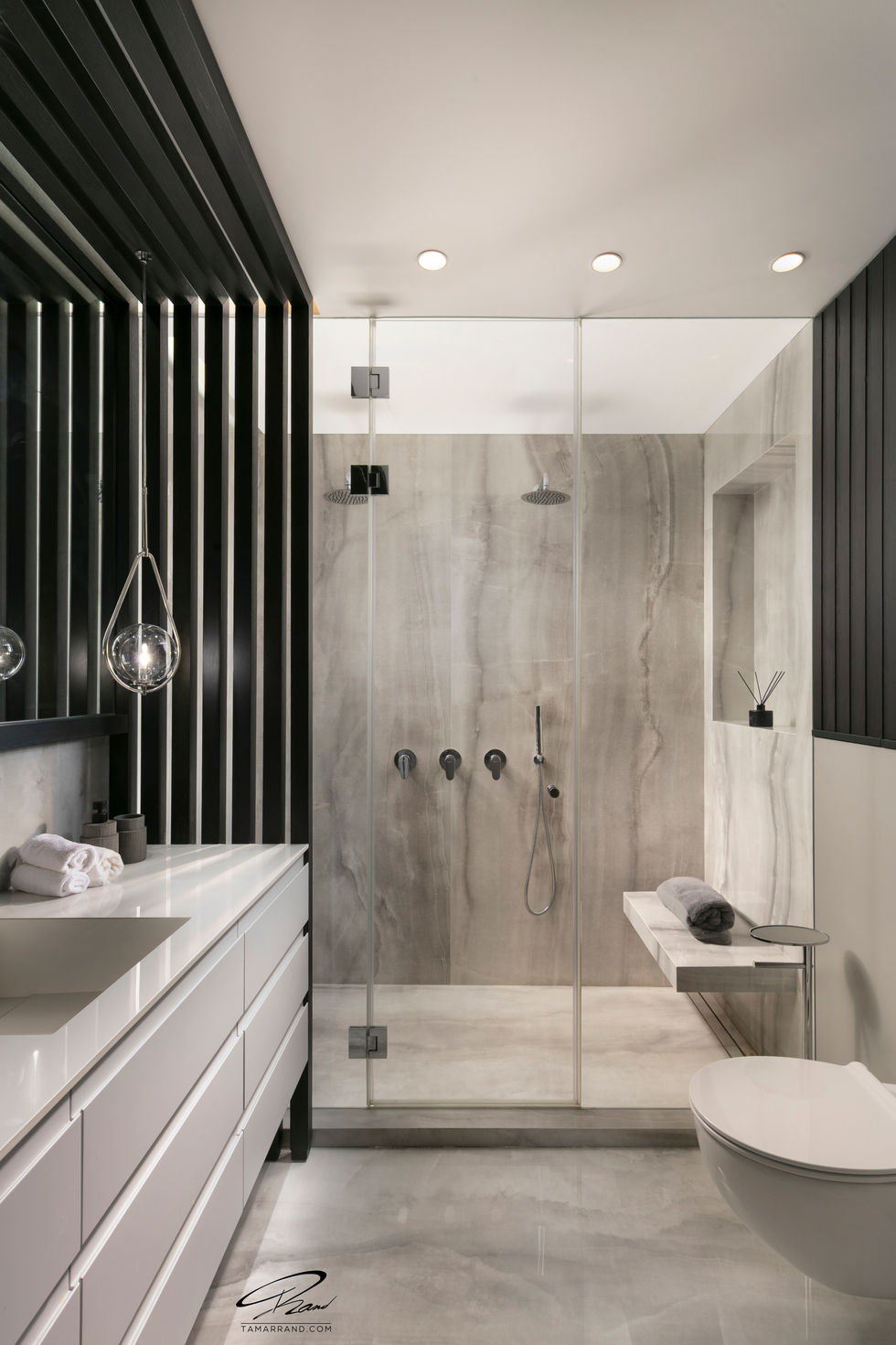Modern bathroom with glass shower and sleek design.