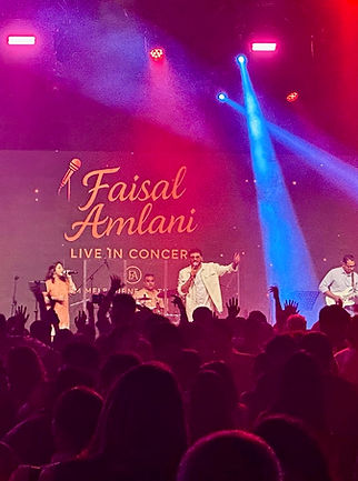Faisal Amlani performing Qawwali Melbourne for a large stadium crowd.
