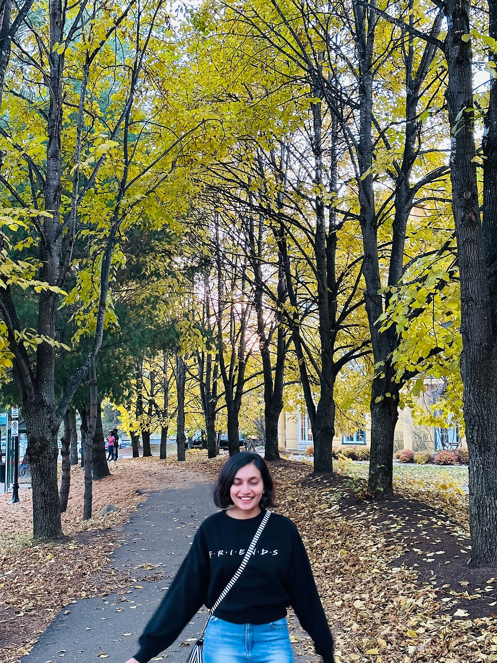It's me, captured on camera while walking on leaf-covered path through autumn trees. I am wearing a "Friends" sweater .