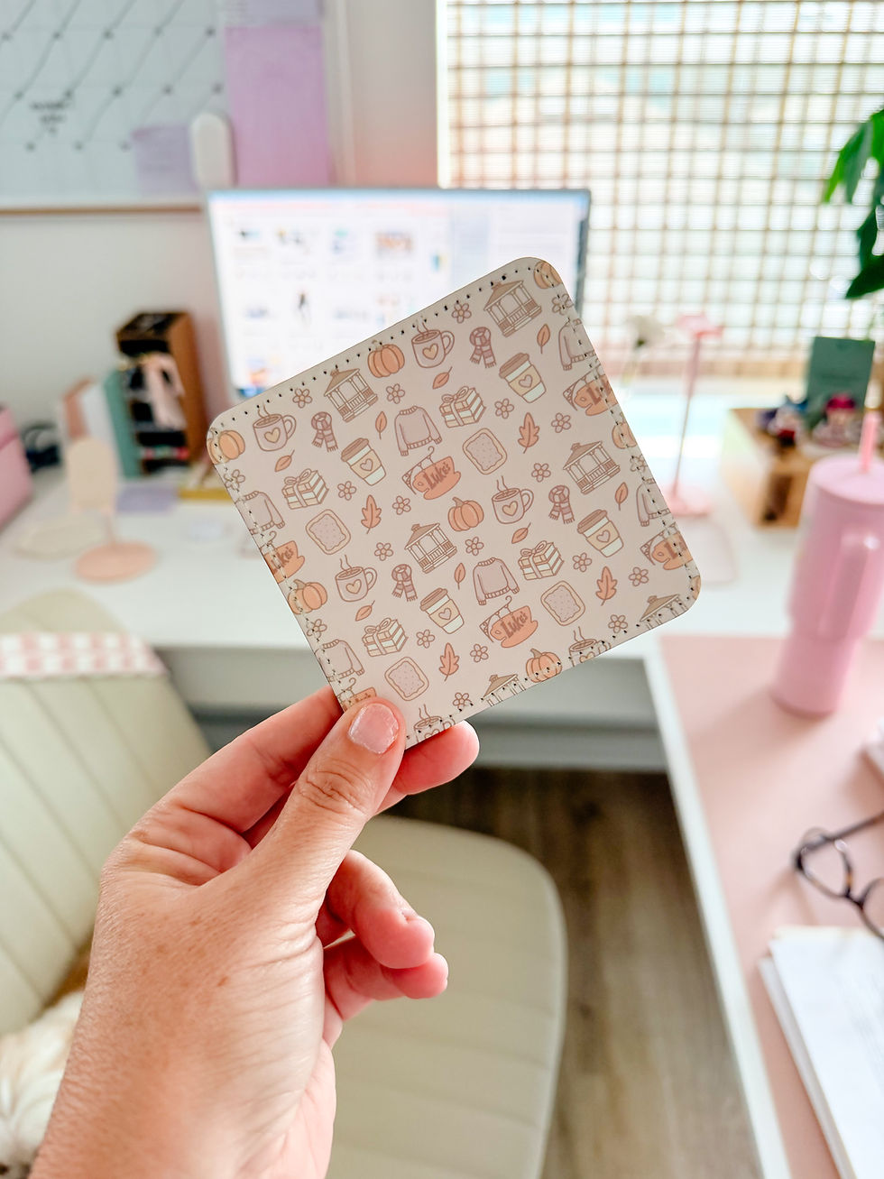 Hand holding a pastel sublimation coaster with a cozy pattern, made using a beginner sublimation setup with an Epson EcoTank printer.