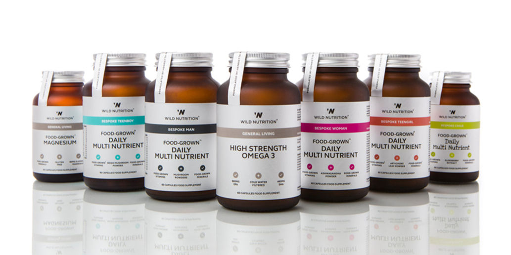 Brand photographer Simon Eldon, wild nutrition food suppliments bottles shot on white background with reflection