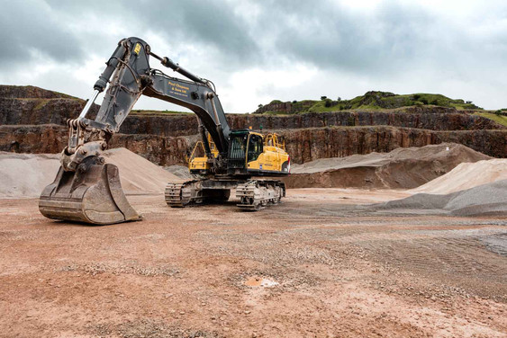 a large industrial digger in an open quarry
