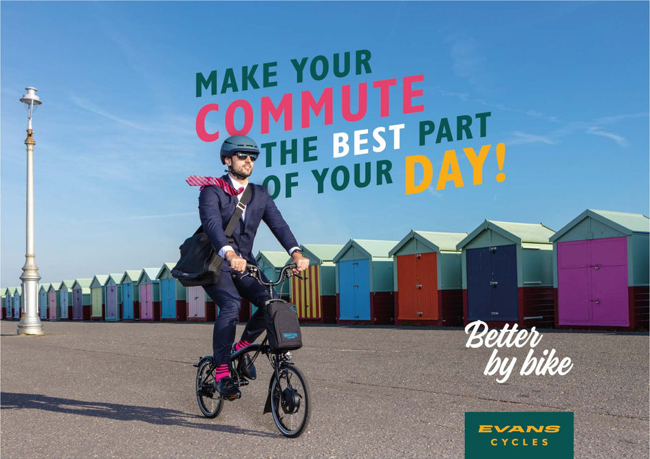 Brand photography by Simon Eldon, advert for evans cycles, a man in a business suit rides a folding bike on brighton seafront with colourful beach huts