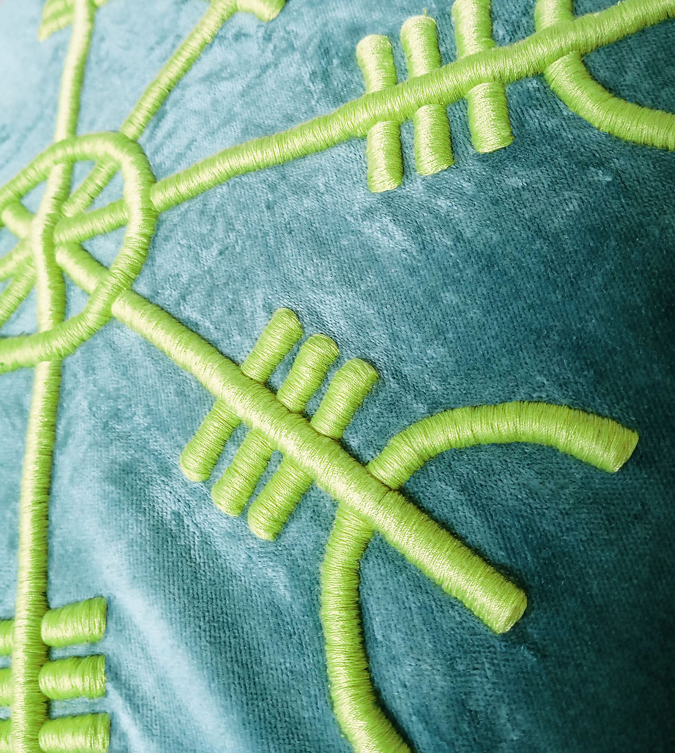 Detailed macro shot of 3D lime green embroidery on textured fabric, showing the intricate stitching of a Viking symbol.