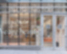 Storefront view of Blushington makeup company with glass windows ceiling to floor.