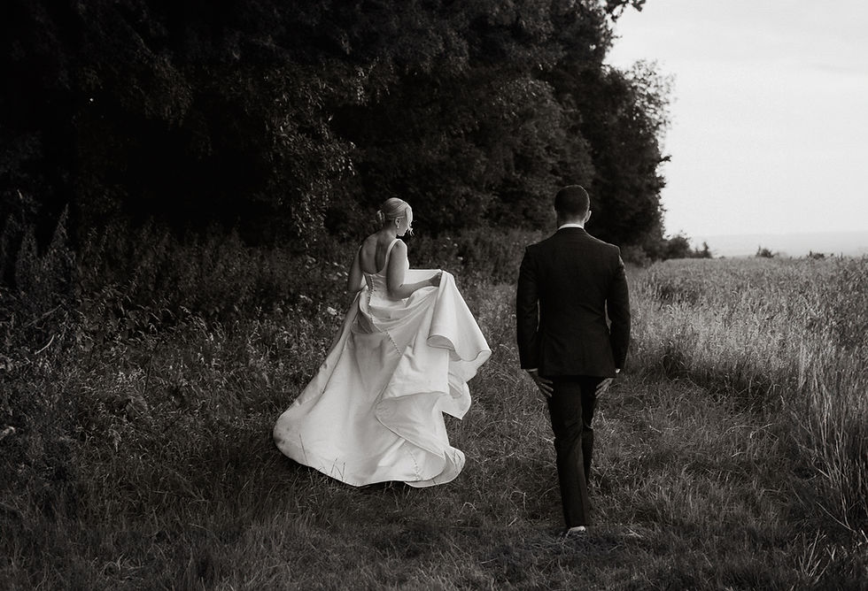 bride and groom walking in the fields in Wiltshire