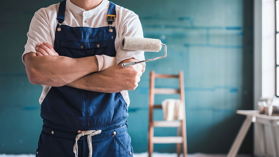 male-painter-with-arm-crossed-holding-paint-roller.jpg
