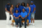 Multi-generational family posing in matching blue outfits.