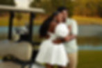 Couple embracing by a golf cart and pond