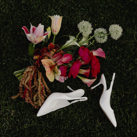 Flowers and shoes on green grass