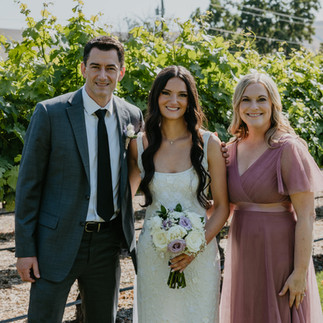 Bride with parents. Leah and Anthony's Summer Wedding at Sugar Pine Barn. Vineyard backdrop.