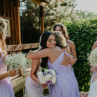 Bridesmaids hug, holding bouquets; Leah and Anthony's Summer Wedding; Washington state wedding photographer