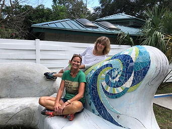 Melissa Haist and Rochelle Rose-Schueler posing on mosaic public art bench project