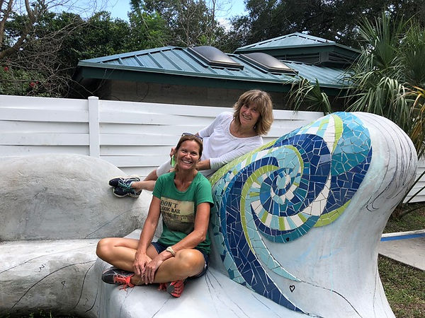 Melissa Haist and Rochelle Rose-Schueler posing on mosaic public art bench project