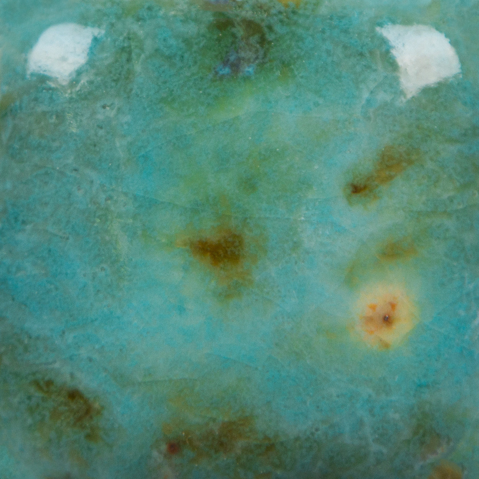 Mayco Blue Guppy ceramic glaze fired to Cone 06, teal with olive and black crystals