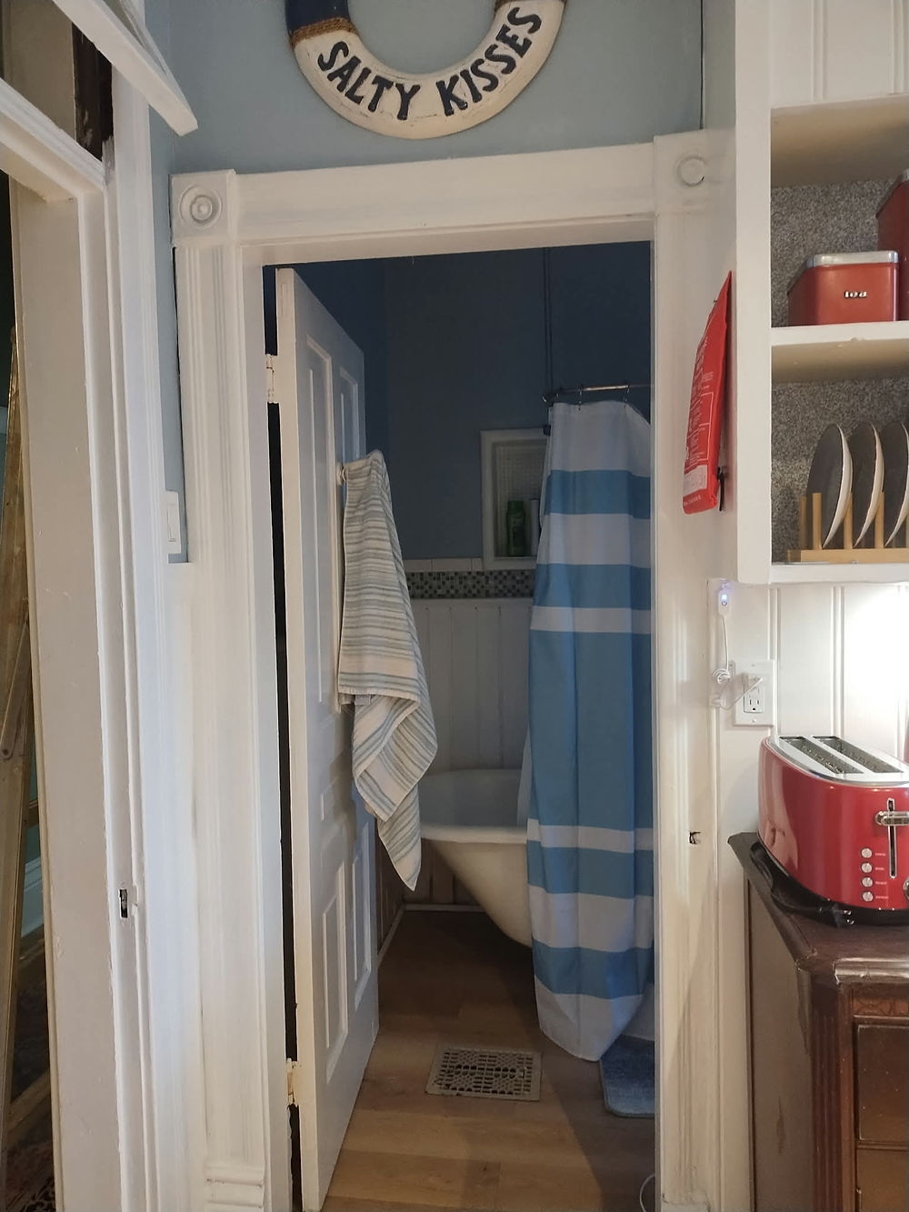 Coastal entry to bathroom with 'Salty Kisses' lifebuoy
