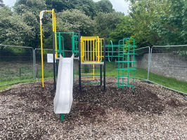 Green and yellow play equipment in playground