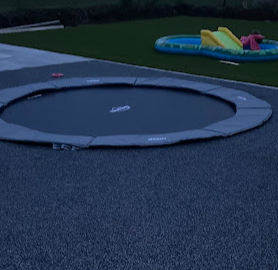 Safety surfacing surrounding in-built trampoline