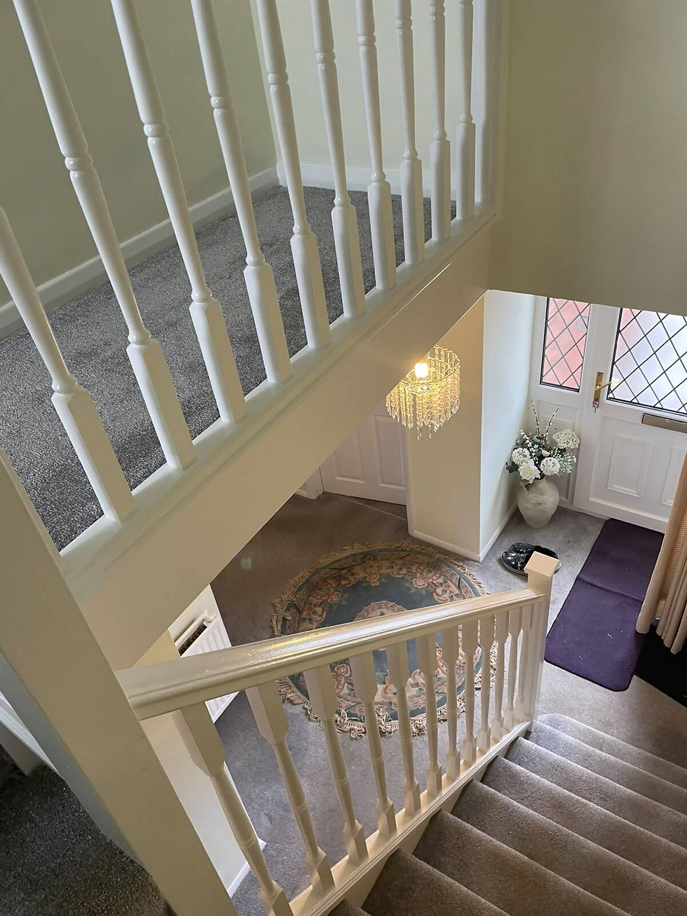 view from top of the stairs newly decorated landing and banister