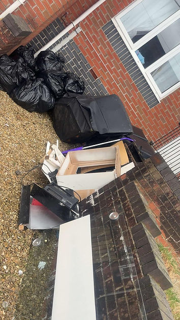 Old sofa and broken bits of furniture with used boxes ready for waste collection
