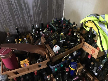 Collection of empty bottles piled up in home