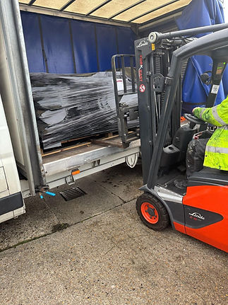 Fork lift putting heavy items in back of truck
