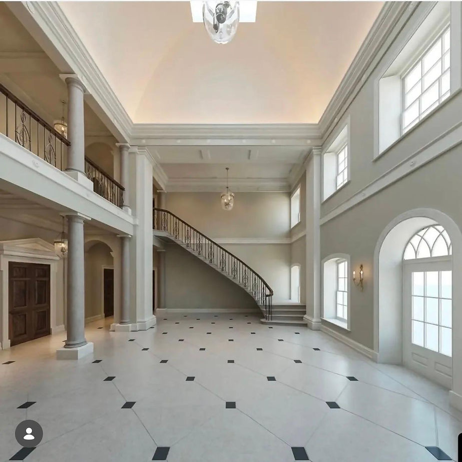 Inside large property with grand stone stair case