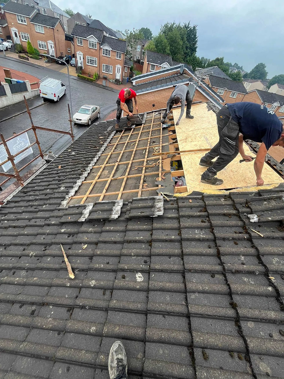 Old roof tile being replaced by a team