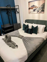 Made bed with swan towels