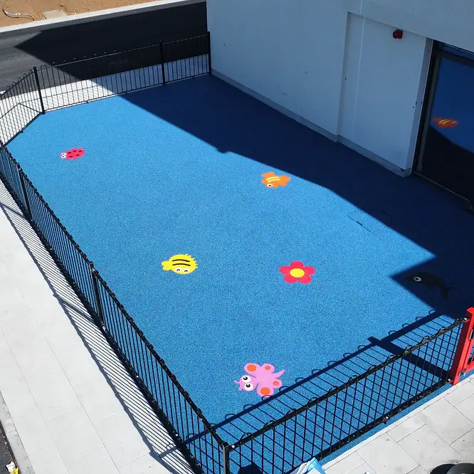 Blue safety surface flooring at nursery with colourful shapes
