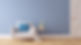 Modern white armchair with blue cushion against blue wall and light wood floors