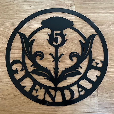 House number and name on metal sign