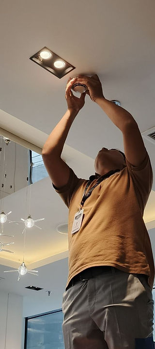 BIJOU staff testing smoke detector