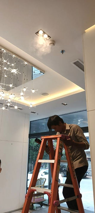 a man testing smoke detector